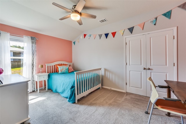 carpeted bedroom with a closet, ceiling fan, and lofted ceiling