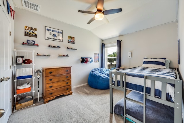 carpeted bedroom with vaulted ceiling and ceiling fan