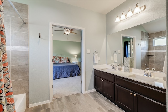 bathroom with vanity, hardwood / wood-style floors, shower / bathtub combination with curtain, and ceiling fan