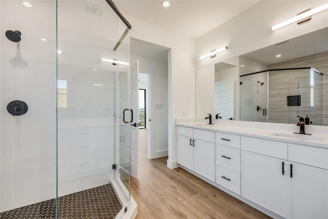 15000 Texas St, Austin, TX 78734 - bathroom with a shower stall, double vanity, wood finished floors, and baseboards
