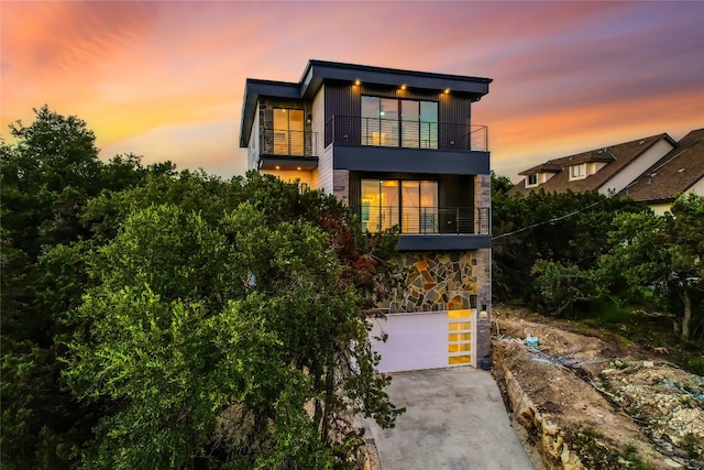 contemporary house with a balcony and a garage