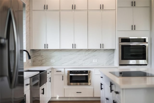 15000 Texas St, Austin, TX 78734 - kitchen with stainless steel appliances, light countertops, backsplash, and white cabinets