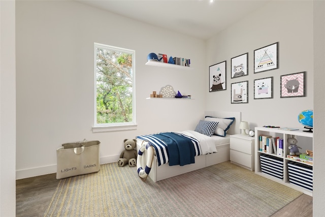 bedroom featuring multiple windows and hardwood / wood-style floors