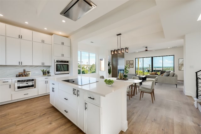 15000 Texas St, Austin, TX 78734 - kitchen featuring black electric cooktop, oven, recessed lighting, light wood-type flooring, and light countertops