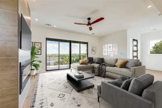 15000 Texas St, Austin, TX 78734 - living room with a large fireplace, a ceiling fan, recessed lighting, and light wood-style floors