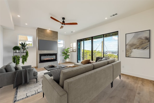 15000 Texas St, Austin, TX 78734 - living area featuring a tile fireplace, a ceiling fan, recessed lighting, baseboards, and light wood-type flooring