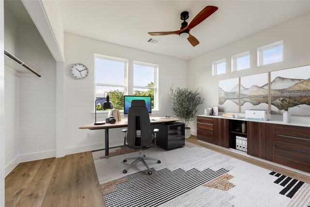 office area with hardwood / wood-style flooring, plenty of natural light, and ceiling fan