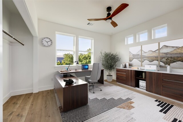 office with ceiling fan and light hardwood / wood-style floors