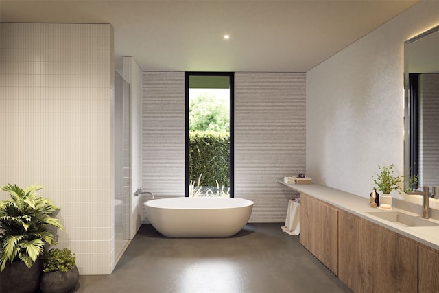 bathroom featuring vanity, a washtub, and concrete floors