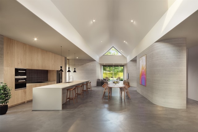 28 Peace Pipe, Wimberley, TX 78676 - interior space with a sink, light brown cabinetry, a breakfast bar area, modern cabinets, and finished concrete flooring
