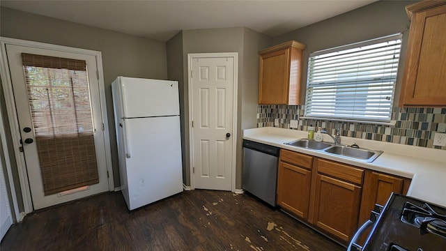 kitchen with gas stove, white refrigerator, stainless steel dishwasher, and tasteful backsplash