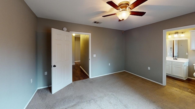 unfurnished bedroom with ceiling fan, sink, carpet, and ensuite bathroom