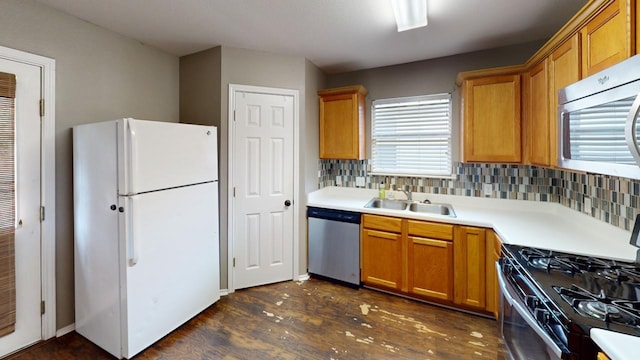 kitchen featuring sink, dark wood-type flooring, appliances with stainless steel finishes, and decorative backsplash