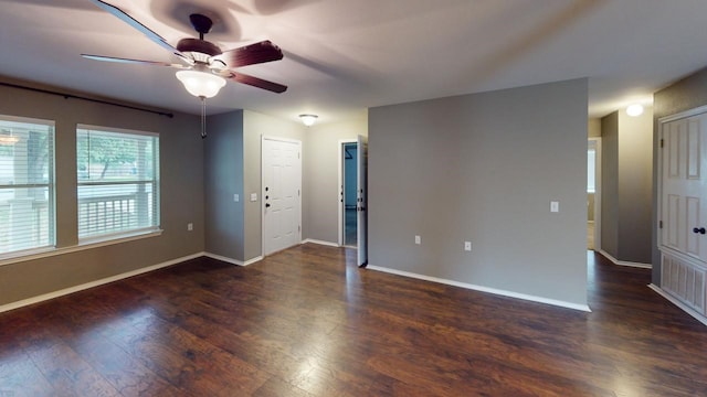 spare room featuring ceiling fan and dark wood-type flooring