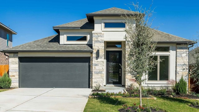 view of front of property with a front lawn and a garage