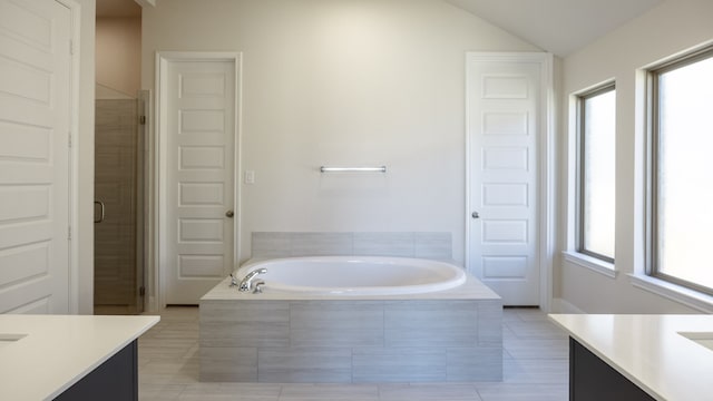 bathroom featuring vanity, lofted ceiling, and plenty of natural light