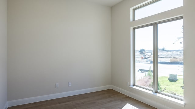 spare room featuring dark wood-type flooring