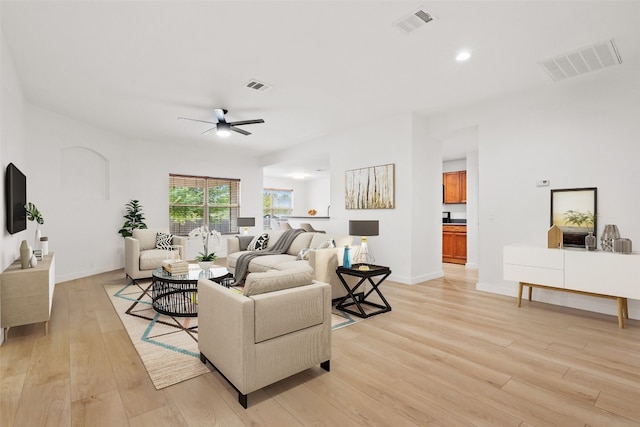 living room featuring ceiling fan and light wood-type flooring