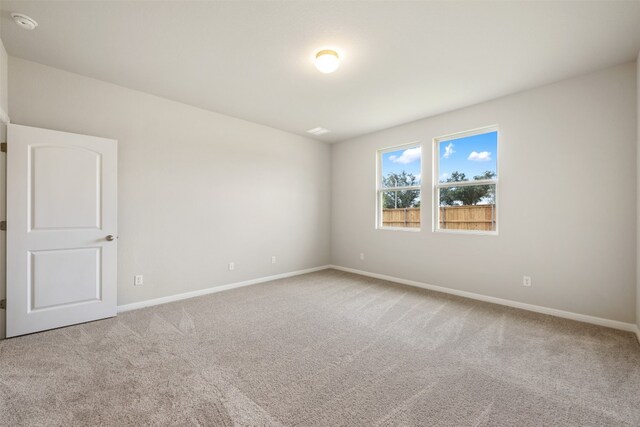 unfurnished room featuring light carpet