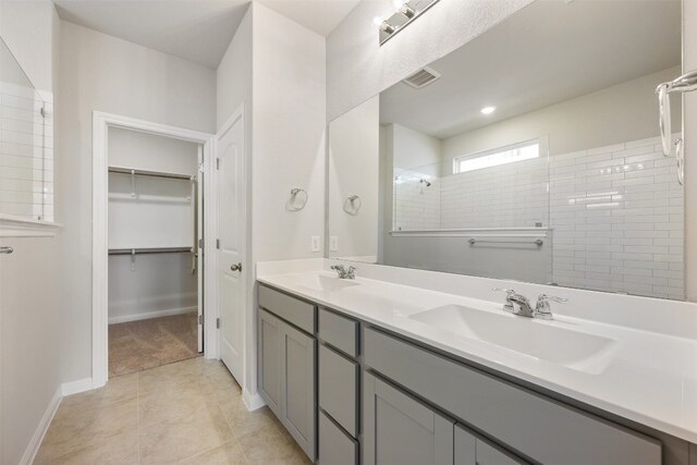 bathroom with vanity, tile patterned floors, and tiled shower