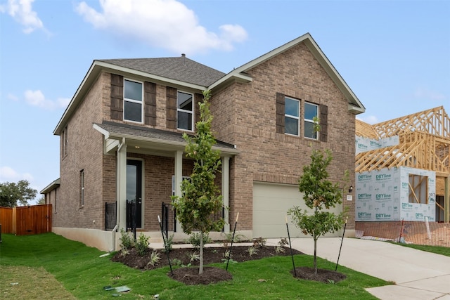 view of front of property with a front lawn and a garage