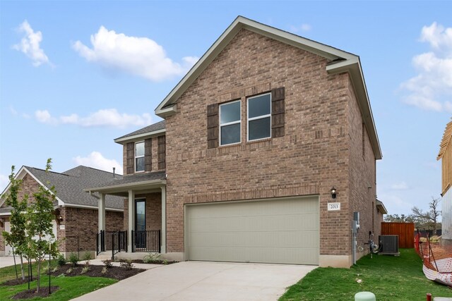 view of front of house with a front yard, a garage, and cooling unit