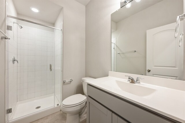 bathroom featuring toilet, walk in shower, and vanity