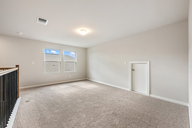 unfurnished room featuring light carpet