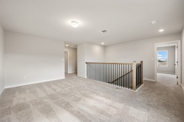 empty room with light colored carpet