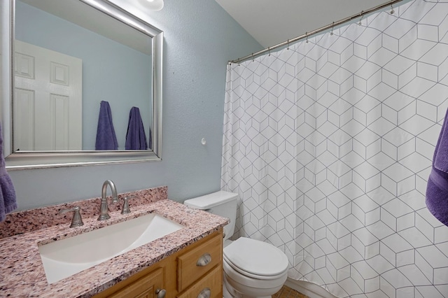 bathroom with toilet, vanity, and curtained shower