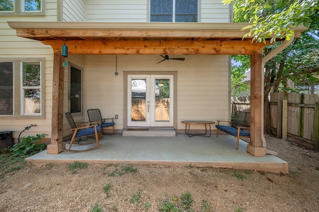 view of exterior entry with ceiling fan, french doors, and a patio