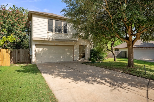 view of front of home with a front lawn and a garage