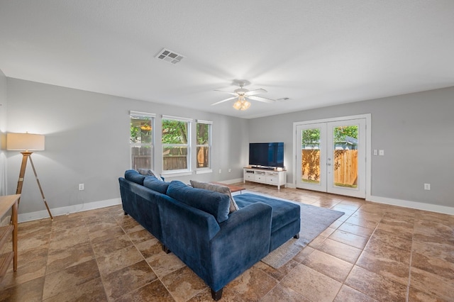 living room featuring ceiling fan and french doors