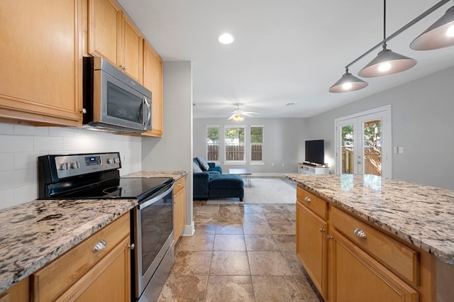 kitchen with appliances with stainless steel finishes, decorative light fixtures, french doors, backsplash, and ceiling fan