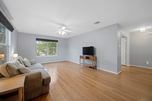 living room with ceiling fan and light wood-type flooring