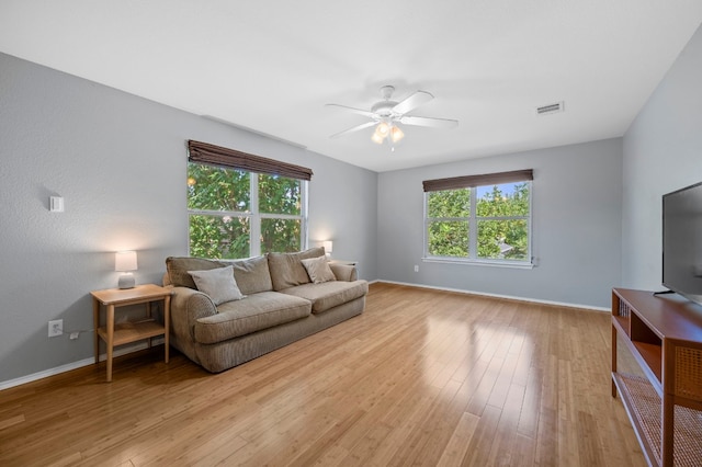 living room featuring ceiling fan and light hardwood / wood-style flooring