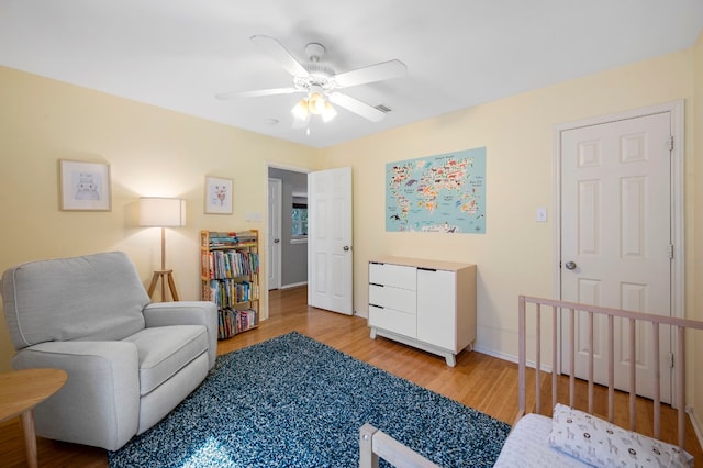 living area featuring ceiling fan and light hardwood / wood-style flooring