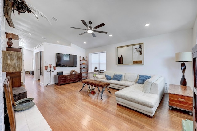 living room featuring vaulted ceiling, ceiling fan, and light hardwood / wood-style floors