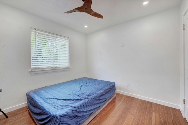 bedroom featuring wood-type flooring and ceiling fan