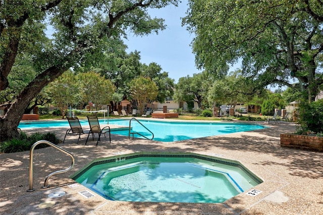 view of swimming pool with a community hot tub and a patio area