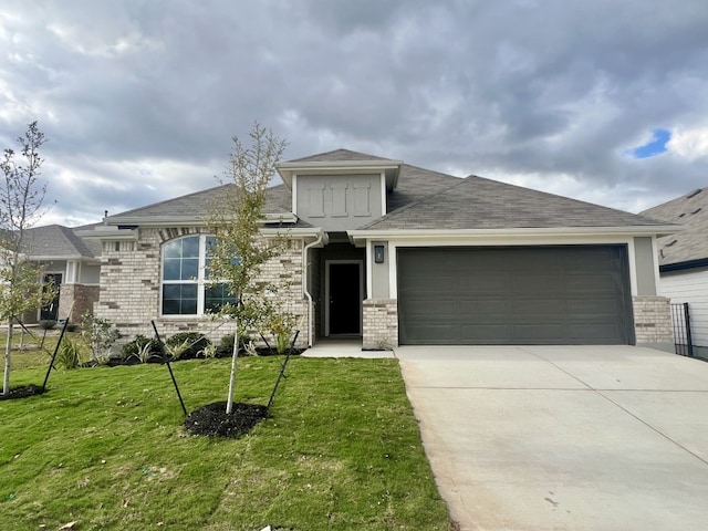 view of front of house with a front lawn and a garage