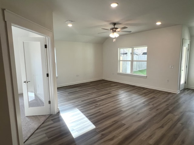 unfurnished room featuring ceiling fan, dark hardwood / wood-style flooring, and lofted ceiling