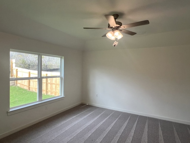 carpeted empty room featuring ceiling fan