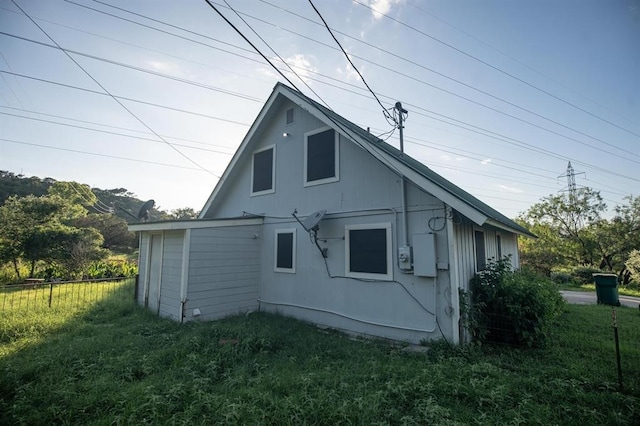 view of side of property with a yard