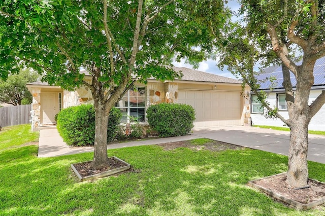 view of front of home featuring stone siding, fence, an attached garage, and concrete driveway