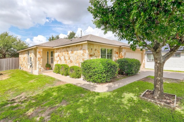 ranch-style house with a front yard, stone siding, fence, and an attached garage