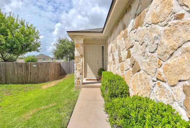 property entrance with a yard