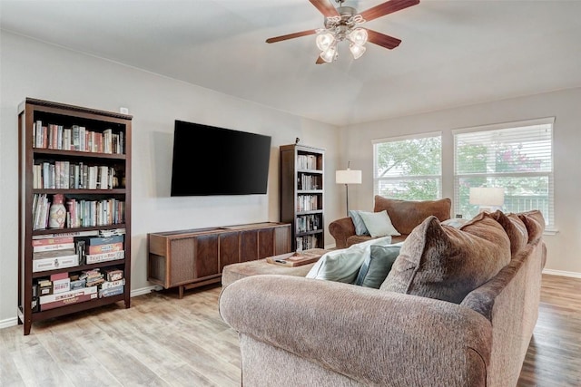 living room featuring wood-type flooring and ceiling fan