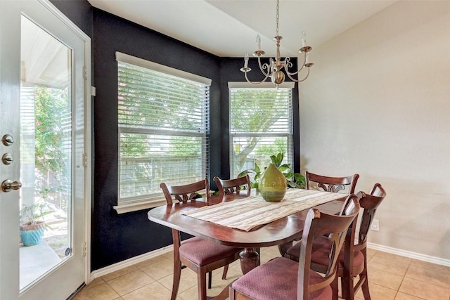 dining room featuring an inviting chandelier, a healthy amount of sunlight, and light tile patterned floors