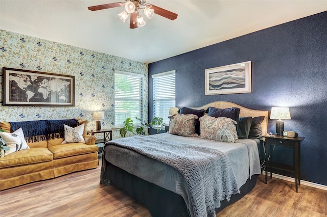 bedroom with ceiling fan and hardwood / wood-style flooring